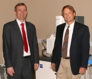 Frank Averdung (left), President and General Manager of Carl Zeiss SMT Inc. hands over the first of a total of eight advanced microscope systems to Eric Martin, technical director at Harvard's CNS. (Photo: Business Wire)