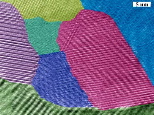 Image / Boston College, MIT, and GMZ Inc.
A cross-section of nano-crystalline bismuth antimony telluride grains, as viewed through transmission electron microscope. Colors highlight the features of each grain of the semiconductor alloy in bulk form. A team of researchers from Boston College and MIT produced a major increase in thermoelectric efficiency after using nanotechnology to structure the material, which is commonly used in industry and research.