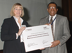 Rene Winsky, President and Executive Director of the Maryland Technology Development Corporation (TEDCO), and NIST Acting Director James Turner with a representation of the Memorandum of Understanding that updates and extends the cooperative relationship between NIST and TEDCO.

Credit: Denease Anderson/NIST