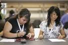 Photo by Christopher Wu

Ana Laurean, left, and Gloria Mateo, freshmen at Reseda High School, complete an assignment as part of the California NanoSystems Institutes High School Day.