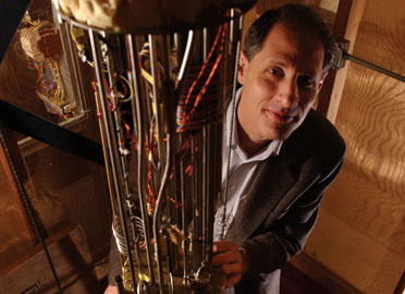 University of Chicago physicist Thomas Rosenbaum, with the helium dilution refrigerator in his laboratory, where he observes the quantum behavior of materials chilled to temperatures approaching absolute zero. (Photo: Dan Dry)