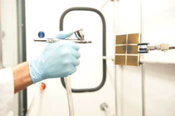 Researchers apply the nanoparticle "inks" as a spray on the solar cells.