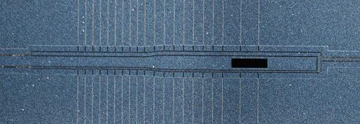 Optical microscope image of an ion trap designed at GTRI. The dark rectangle is the loading slot that calcium atoms stream through before they are hit with a laser and trapped. Credit: Charlie Doret