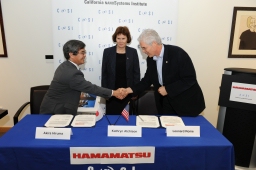 UCLA's Leonard Rome and Kathryn Atchison with Hamamatsu's Akira Hiruma at Sept. 1 signing ceremony.