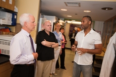 Morton Schapiro, Samuel Stupp, Dorota Rozkiewicz, and Kathy Burgess (from left) listen as Guillermo Ameer (right) discusses his research on liquid vascular stints.