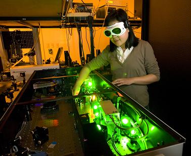 Purdue mechanical engineering doctoral student Yaguo Wang works with a high-speed laser at the Birck Nanotechnology Center to study thermoelectric generators. The devices harvest heat from an engine's exhaust to generate electricity, which could reduce a car's fuel consumption. (Purdue University photo/Mark Simons)