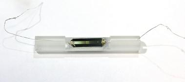 The apparatus shown here contains a phosphorus-doped silicon chip, only 1 millimeter square, that was used to demonstrate how data can be stored in magnetic "spins" within the centers or nuclei of phosphorus atoms, and then how that data can be accessed and read electronically. Photo Credit: C. Dane McCamey, The University of Utah