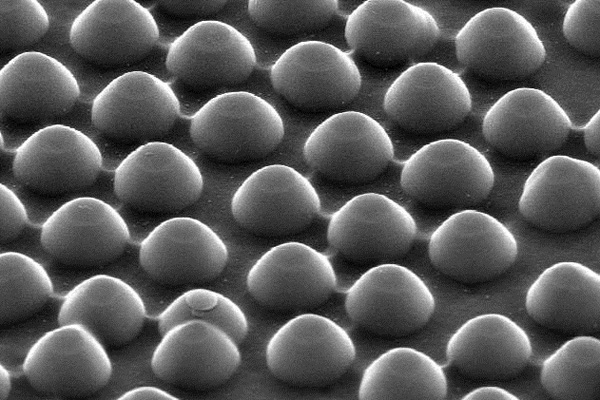 Acting like a waffle iron, silicon nanodomes, each about 300 nanometers in diameter and 200 nanometers tall, imprint a honeycomb pattern of nanoscale dimples into a layer of metal within the solar cell. Courtesy of Michael McGehee