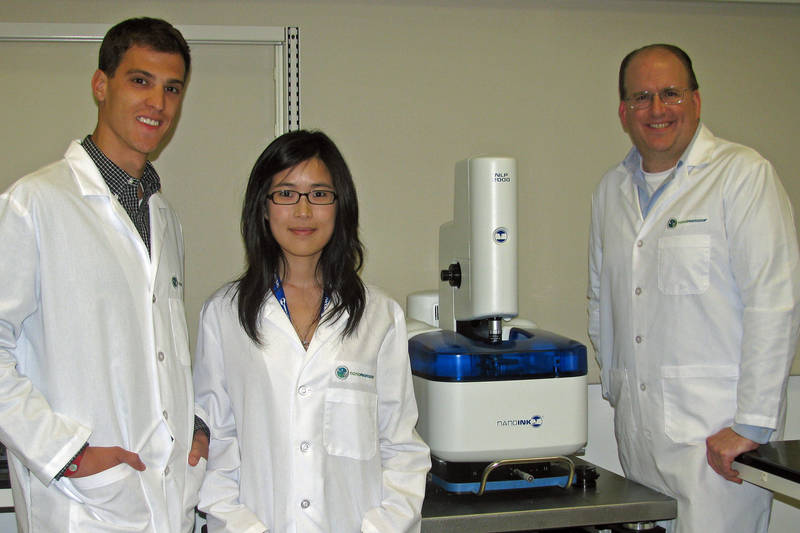 From Left to Right: NanoProfessor Interns Troy Blume and Da In Lee with Dr. John Ireland, Director of the NanoProfessor Program and NanoInk's NLP 2000 Desktop Nanofabrication System.