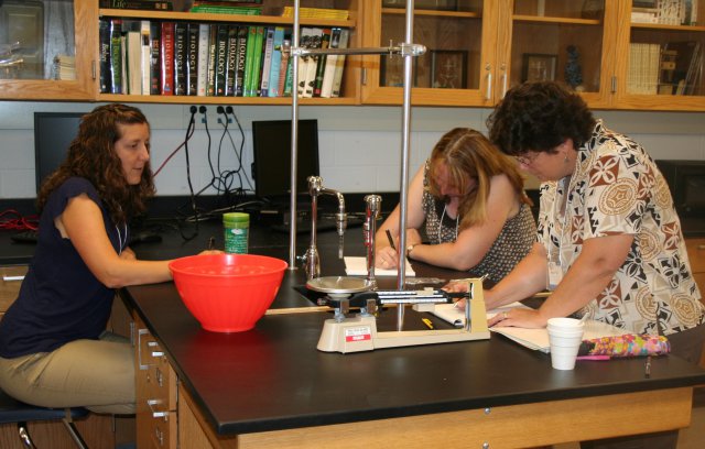 As part of the Food Packaging Training, Elkton High School biology teacher Wendy Luber, Perryville High School science teacher Stacie Forman and Edgewood Chemical Biological Center Packaging Specialist Mary Peck design an environmentally friendly package for delivering a hot baked potato.