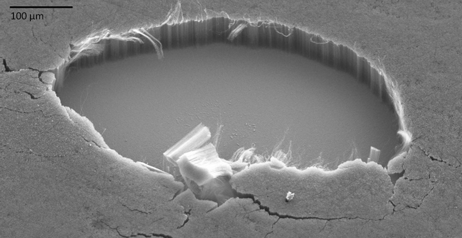 This close-up view (only about 0.03 inches wide) shows the internal structure of a carbon-nanotube coating that absorbs about 99 percent of the ultraviolet, visible, infrared, and far-infrared light that strikes it. A section of the coating, which was grown on smooth silicon, was purposely removed to show the tubes' vertical alignment. (Credit: Stephanie Getty, NASA Goddard)