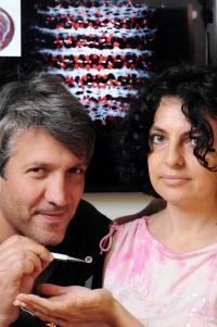 Georgia Tech researchers Angelo Bongiorno and Elisa Riedo pose with a graphene oxide sample, with a computer model of the materials structure shown behind them.

Credit: Georgia Tech Photo: Gary Meek