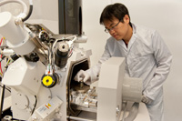 The tiny patterns are formed on the gold surface using a process called ion beam milling (the focused ion beam system is used to create nanoscale intaglio metamaterial patterns on the metal surface. Here we can see the gold substrate being loaded.