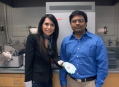 MIT postdoc Gisele Azimi, left, displays three of the 13 different ceramic disks made from oxides of the rare earth elements, with associate professor Kripa Varanasi. Behind them is the furnace used to convert the powdered oxides into solid ceramic form.
Photo: David Castro-Olmedo/MIT