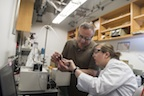 Rice University chemist Andrew Barron and graduate student Brittany Oliva-Chatelain investigate the prototype of a device that allows for rapid testing of nanotracers for the evaluation of wells subject to hydraulic fracturing. Credit: Jeff Fitlow/Rice University