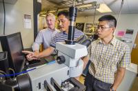 Sandia National Laboratories researcher Hongyou Fan, center, points out a pressure result at the nanoscale to Sandia paper co-authors Paul Clem, left, and Binsong Li.

Credit: Photo by Randy Montoya, Sandia National Laboratories