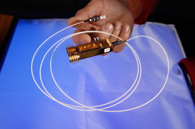 This small device developed at Los Alamos National Laboratory uses the truly random spin of light particles as defined by laws of quantum mechanics to generate a random number for use in a cryptographic key that can be used to securely transmit information between two parties. Quantum key distribution represents a foolproof cryptography method that may now become available to the general public, thanks to a licensing agreement between Los Alamos and Whitewood Encryption Systems, LLC. Los Alamos scientist developed their particular method for quantum cryptography after two decades of rigorous testing inside of the nation's premier national security science laboratory. Photo credit: Los Alamos National Laboratory