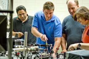 University of Vermont scientists have invented a new way to create what they are calling an electron superhighway in an organic semiconductor that promises to allow electrons to flow faster and farther -- aiding the hunt for flexible electronics, organic solar cells, and other low-cost alternatives to silicon. To explore these organic materials, UVM graduate students (from left) Naveen Rawat and Lane Manning, and professors Randy Headrick and Madalina Furis, deployed this table-top scanning laser microscope. Their latest finding is reported in the journal Nature Communications -- and may, someday not too far off, let you roll up your computer like a piece of paper.
CREDIT: Joshua Brown, UVM