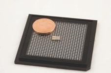 Using photonic integrated circuit technology, researchers made a tiny, yet fast quantum random number generator. The small chip in the middle of the picture contains two of the random number generators, which together measure 6 by 2 millimeters. For comparison, the coin is 16.25 millimeters in diameter.
CREDIT: Daniel Bartolome & Ona Bomb, ICFO